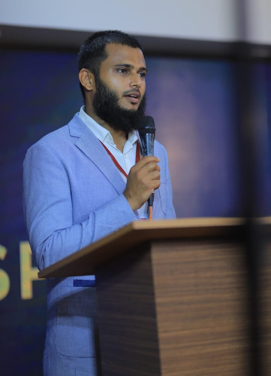 Yasar Moideen VP, Director of Y's Educators, speaking at a podium